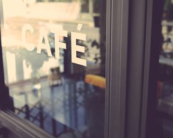 Door to a cafe with thn words CAFE on it